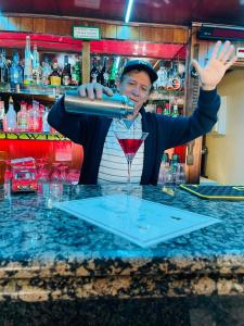 a man pouring a drink at a bar at Casa Do Canto in Albufeira +241 photos