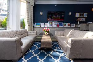 a living room with two couches and a table at Applewood Hotel in Bournemouth