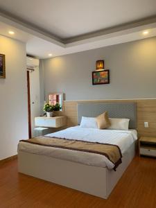 a bedroom with a large bed in a room at Hong Thien 1 Hotel in Hue