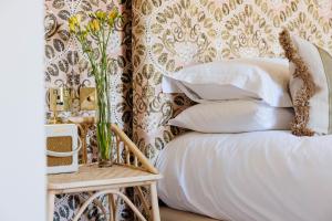 a bedroom with a bed and a table with a vase of flowers at The Yard in Bath Hotel in Bath