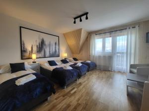 Postel nebo postele na pokoji v ubytování Apartament z widokiem na panoramę Tatr "AppWidokowa9"