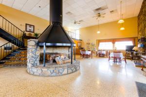 a fireplace in the middle of a living room at OYO Hotel Lebanon MO I-44 in Lebanon