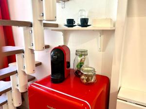 a red appliance sitting on top of a red refrigerator at Orvieto10 in Milan