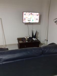 ein Wohnzimmer mit einem Sofa und einem Flachbild-TV in der Unterkunft Domvs 84 in Torre Annunziata