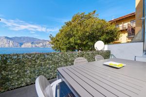 un tavolo con sedie e vista sull'acqua di Lake Front Casa Christina a Malcesine