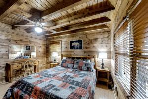 a bedroom with a bed and a wooden wall at Mountain Lion's Tales in Gatlinburg