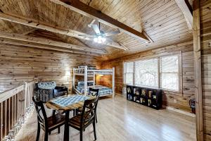 a dining room with a table and chairs in a cabin at Mountain Lion's Tales in Gatlinburg