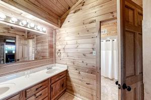 a bathroom with a sink and a mirror at Mountain Lion's Tales in Gatlinburg +27 photos