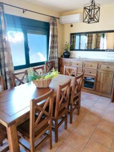 a dining room with a wooden table and chairs at FINCA VALDELAJARA a 20 minutos de Puy du Fou in Toledo