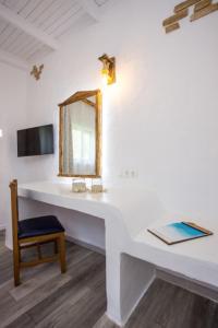 a white counter with a mirror and a chair at Faliraki Blue Villas in Faliraki