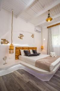 a bedroom with a large bed in a room at Faliraki Blue Villas in Faliraki