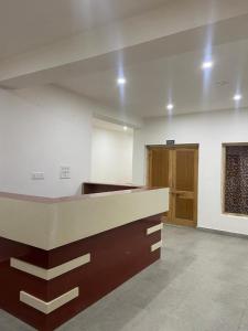 an empty room with a kitchen with a counter top at Nima's Villa in Leh