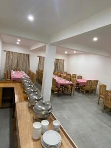 a row of tables and chairs in a restaurant at Nima's Villa in Leh