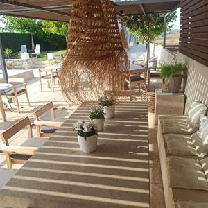 a long table with potted plants on a patio at Niovi Boutique Apartments in Afitos