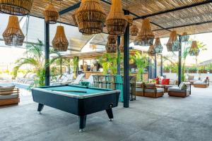 a pool table in the middle of a patio at Mayan Monkey Los Cabos in Cabo San Lucas