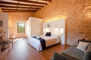 ein Schlafzimmer mit einem Bett und einem Sofa in einem Zimmer in der Unterkunft Agroturisme Son Samà in Llucmajor