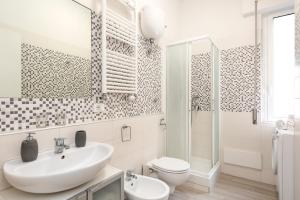 a white bathroom with a sink and a toilet at Roma Chic Flat Gemelli in Rome +19 photos