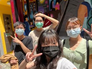 a group of people wearing masks posing for a picture at mydeer backpacker in Tainan
