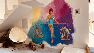 a woman on a pole painted on a wall at Cabañas Sicarú Mazunte in Mazunte