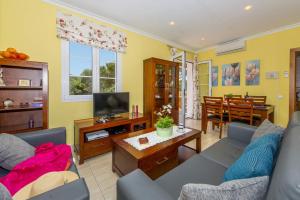un salon avec un canapé et une télévision dans l'établissement Villa Carmen Galdana by Villa Plus, à Cala Galdana