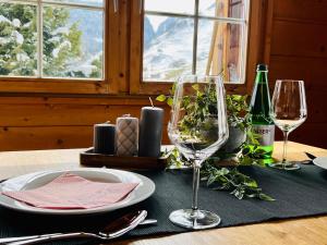 Maisonette Franz في فال: طاولة مع كأسين من النبيذ على طاولة