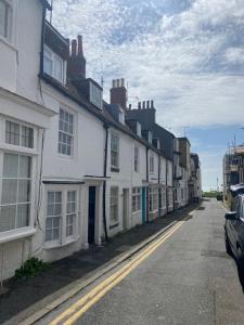 a row of white houses on a street at Salt Life Cottage in Brighton & Hove