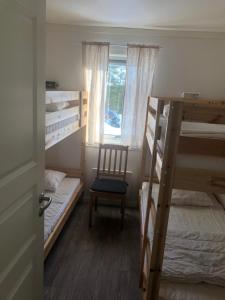 a room with two bunk beds and a chair at Hede, stuga in Hede