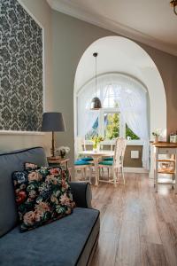 a living room with a couch and a table at Cherry House Apartments in Bydgoszcz