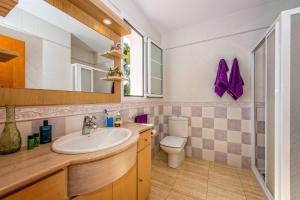 a bathroom with a sink and a toilet at Villa Dolores by Villa Plus in Cala Galdana +15 photos
