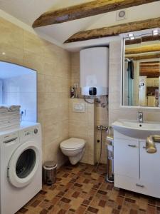 a bathroom with a washing machine and a sink at Veneto in Perast