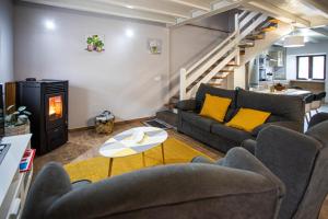 a living room with a couch and a table at Casa de campo en Llanes para 8 personas in La Galguera