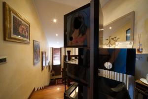 a room with a hallway with paintings on the walls at B&BMagicHouse in Novara