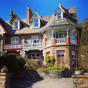 a large brick house with a balcony on top at Southcliffe B&B in Lynton