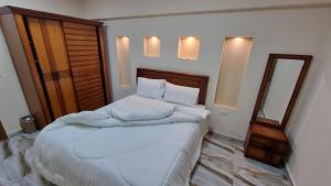 A bed or beds in a room at Alex sea view apartment - families only