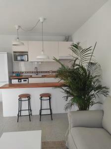 a kitchen with a couch and two bar stools at Cráter 1 in El Paso