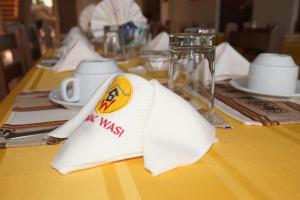 une table avec une serviette blanche sur une table jaune dans l'établissement Sumac wasi, à Chivay