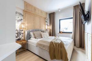 Łóżko lub łóżka w pokoju w obiekcie Modrzejewska Residence Zakopane
