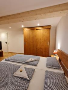 a bedroom with a bed with two napkins on it at Allgäuer Heimat in Rettenberg