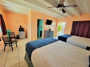 a hotel room with two beds and a ceiling fan at Looe Key Reef Resort and Dive Center in Summerland Key