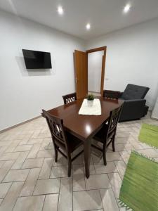 a dining room with a table and a couch at Deus Accomodation in Tropea