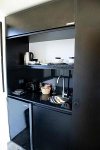 a kitchen with a sink and a counter top at Flamencos Rosados in José Ignacio