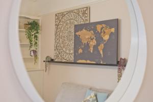 a mirror in a living room with a map on the wall at Malleus House in Barrow in Furness