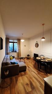 a living room with a couch and a table at Pelican - Czarny Dwór A in Zaspa