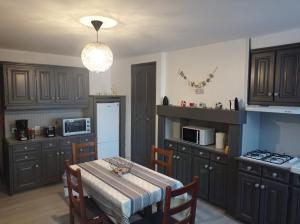 a kitchen with wooden cabinets and a table with a tableablish at Chez Simone in Le Tréport