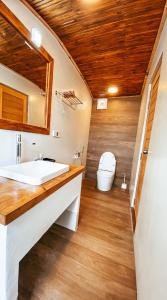 a bathroom with a sink and a toilet at Island Zephyr in Baa Atoll