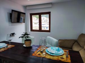 a dining room with a table and a couch at Casa Liberatina in Cudillero