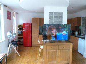 a kitchen with a flat screen tv on a table at Lovely 2 bed flat in the VERY CENTRE of Newcastle in Newcastle upon Tyne