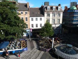 a group of people sitting at tables on a city street at Lovely 2 bed flat in the VERY CENTRE of Newcastle in Newcastle upon Tyne