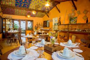 a dining room with a table with dishes on it at Pousada Mar Aberto in Fernando de Noronha