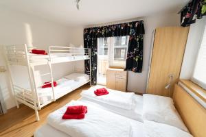 a bedroom with two bunk beds with red pillows on them at Alpin Apartments in Maria Alm am Steinernen Meer